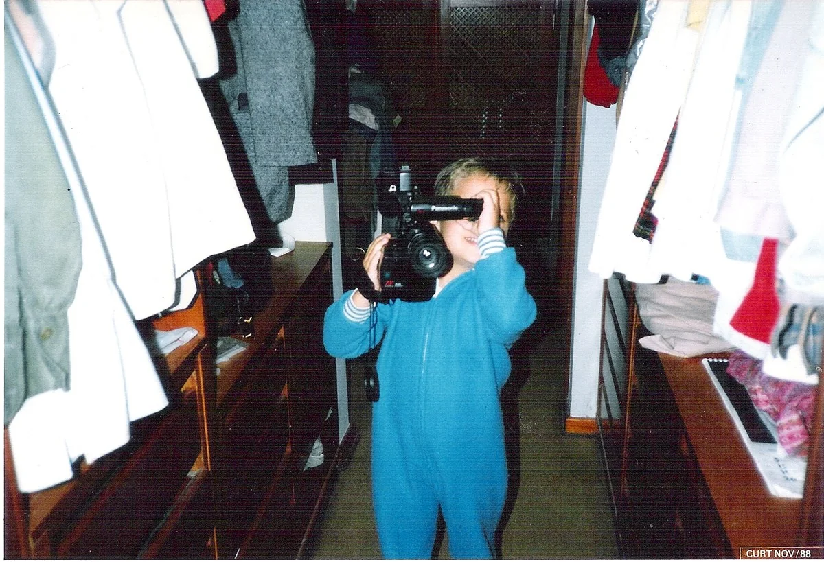 Erik as a child in 1988, filming with a camcorder.